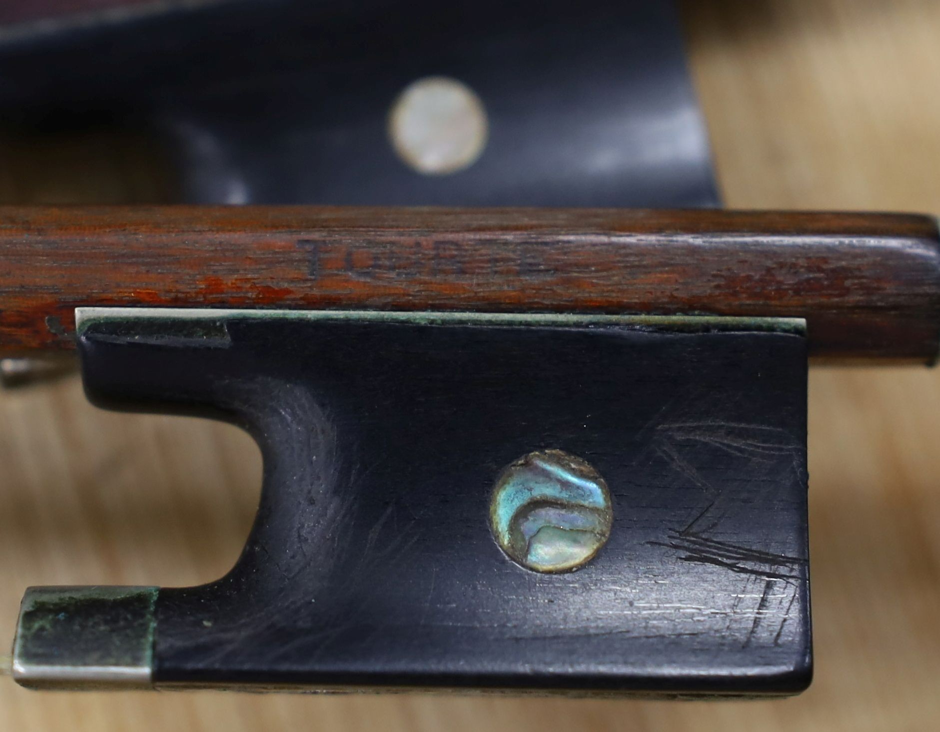 A 19th century violin labelled JB Guadagnini, back measures 35cm, with two bows, one silver-mounted.